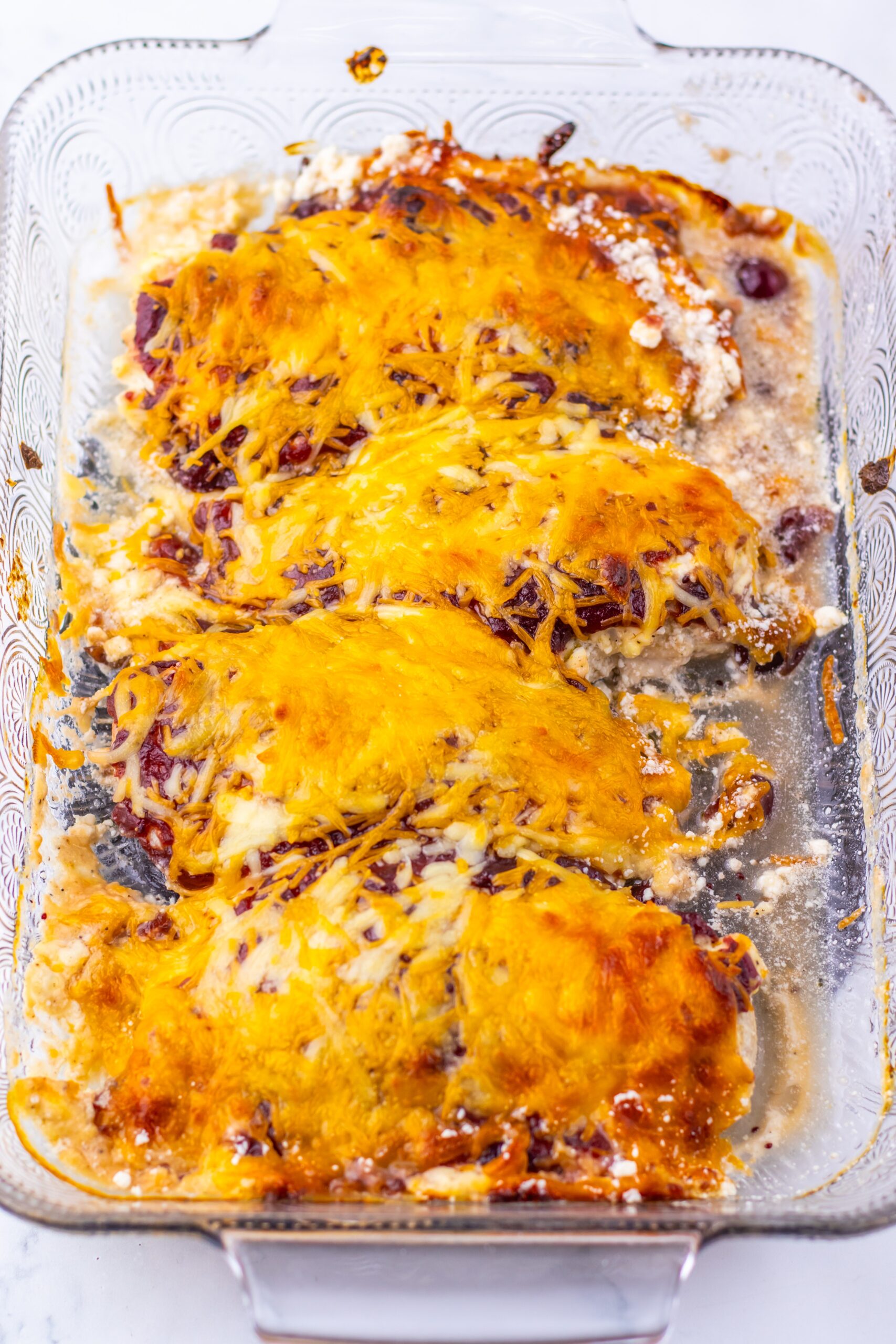 Bake until the chicken is cooked through and the cheese is melted, then rest and add parsley.