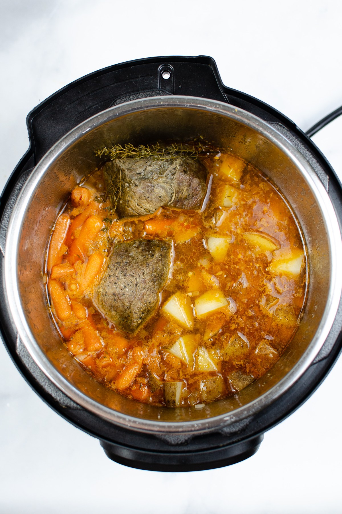 Lift out the roast, shred it, and serve it with the vegetables and broth.