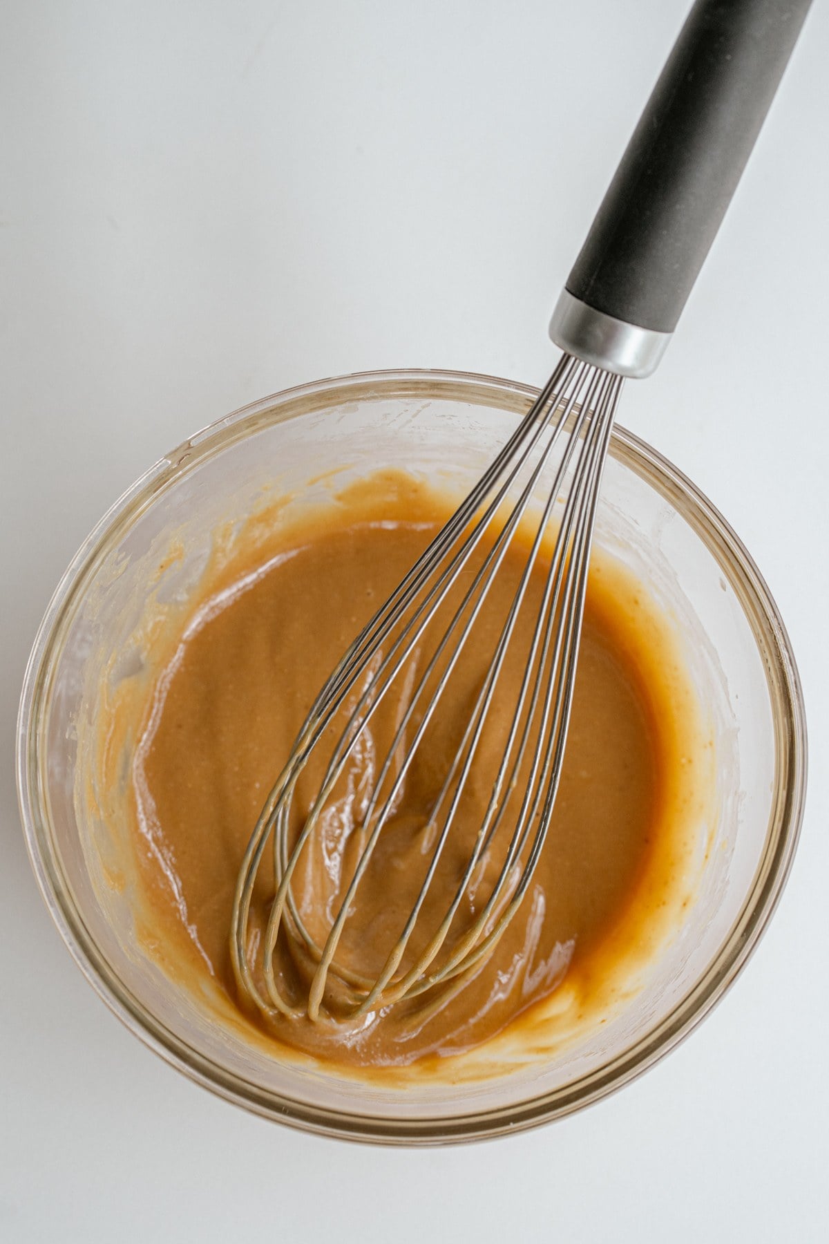 Peanut butter caramel being whisked together.